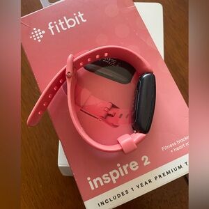 Fitbit Inspire 2 in dusty pink. Fitness tracker, syncs with your phone.